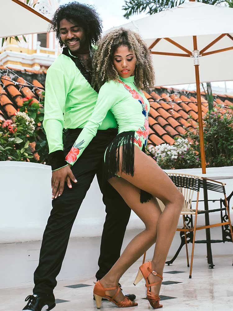 Couple learning salsa from expert teachers on the rooftop of Amarla Hotel, one of many things to do in Cartagena