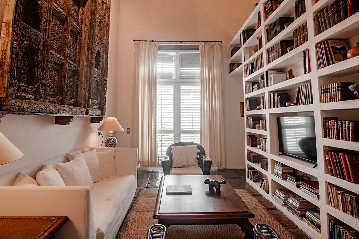 View from the doorway, of the large king bed on the right and writing desk in front of the windows at the far end of the Heron en-suite room.